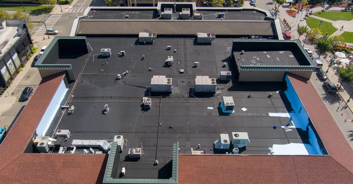 Old commercial roof with visible damage and worn-out coating before restoration by Premier National Roofing